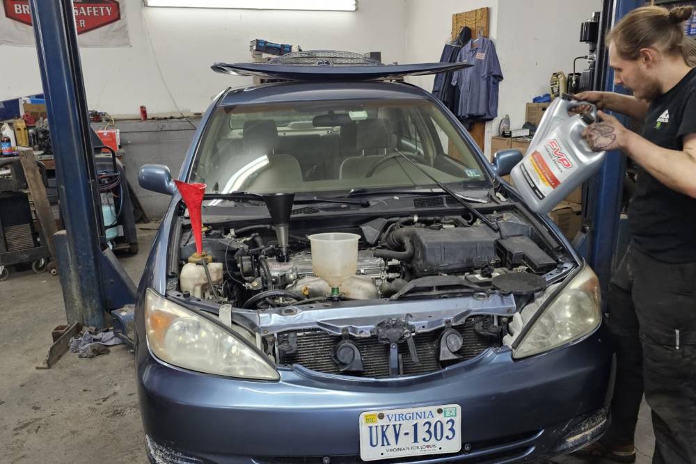 Mechanic examining car in auto car repair Ballenger’s Service Center